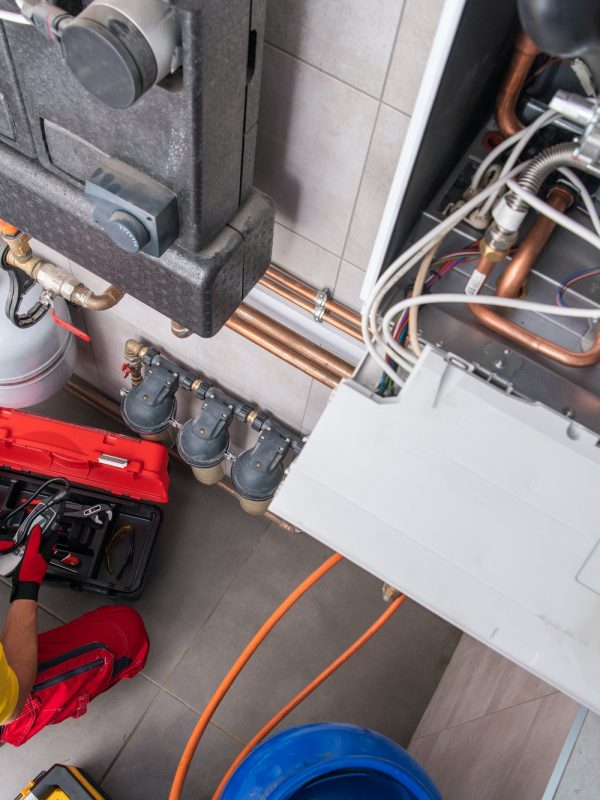 Residential Heating Systems Technician Performing Maintenance